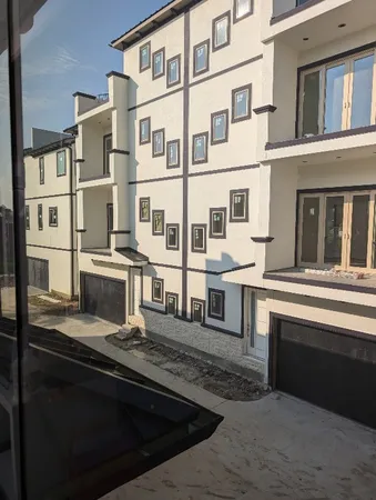 a kitchen with kitchen island stainless steel appliances a sink and a refrigerator