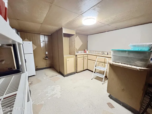 a view of a storage & utility room with two washing machine