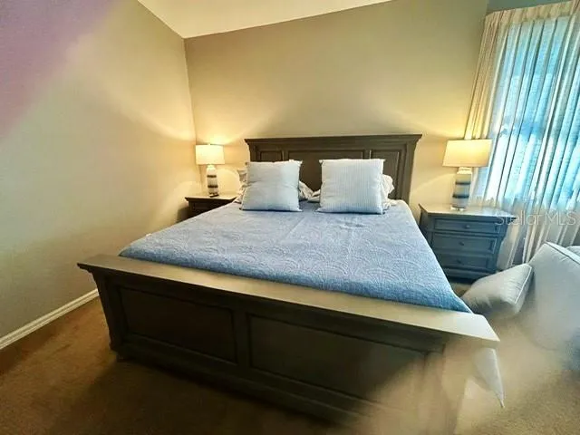 a bedroom with a bed and lamps