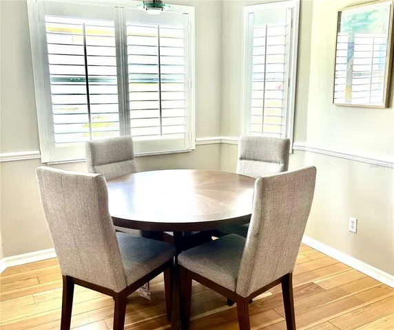 a view of a dining room with furniture and a window