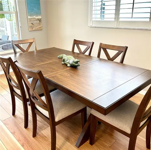 a view of a dining room with furniture and window