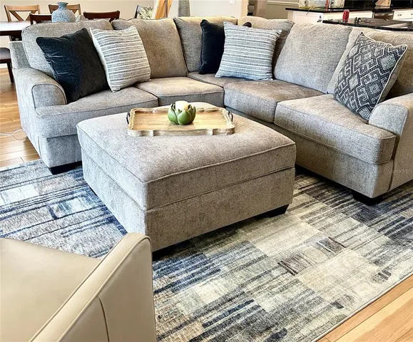 a living room with furniture and a rug