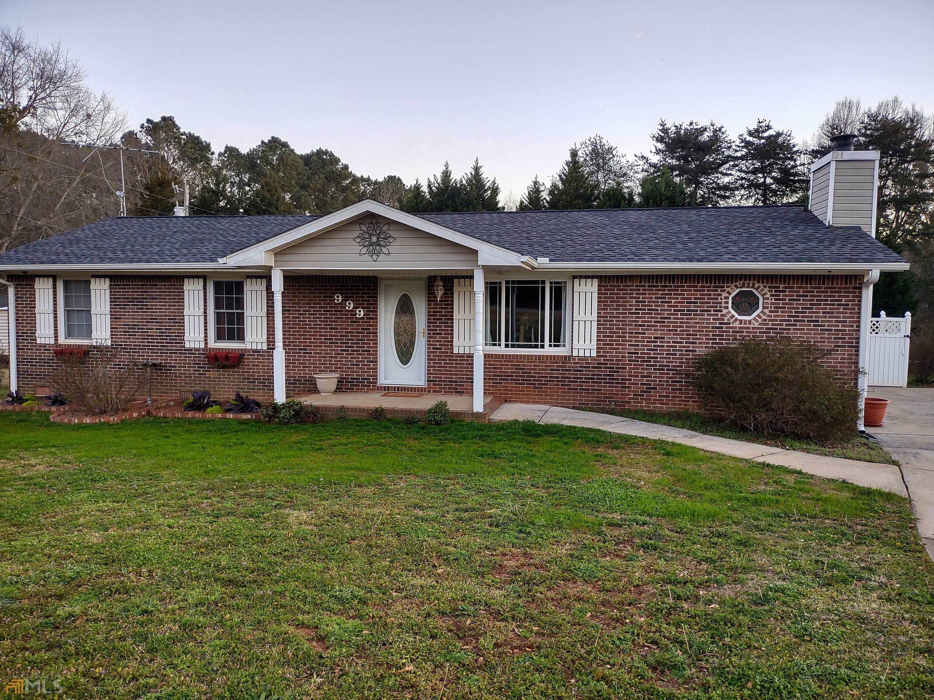 999 Walker Drive Locust Grove, GA 30248 - Photo 1 of 1 a front view of a house with a garden