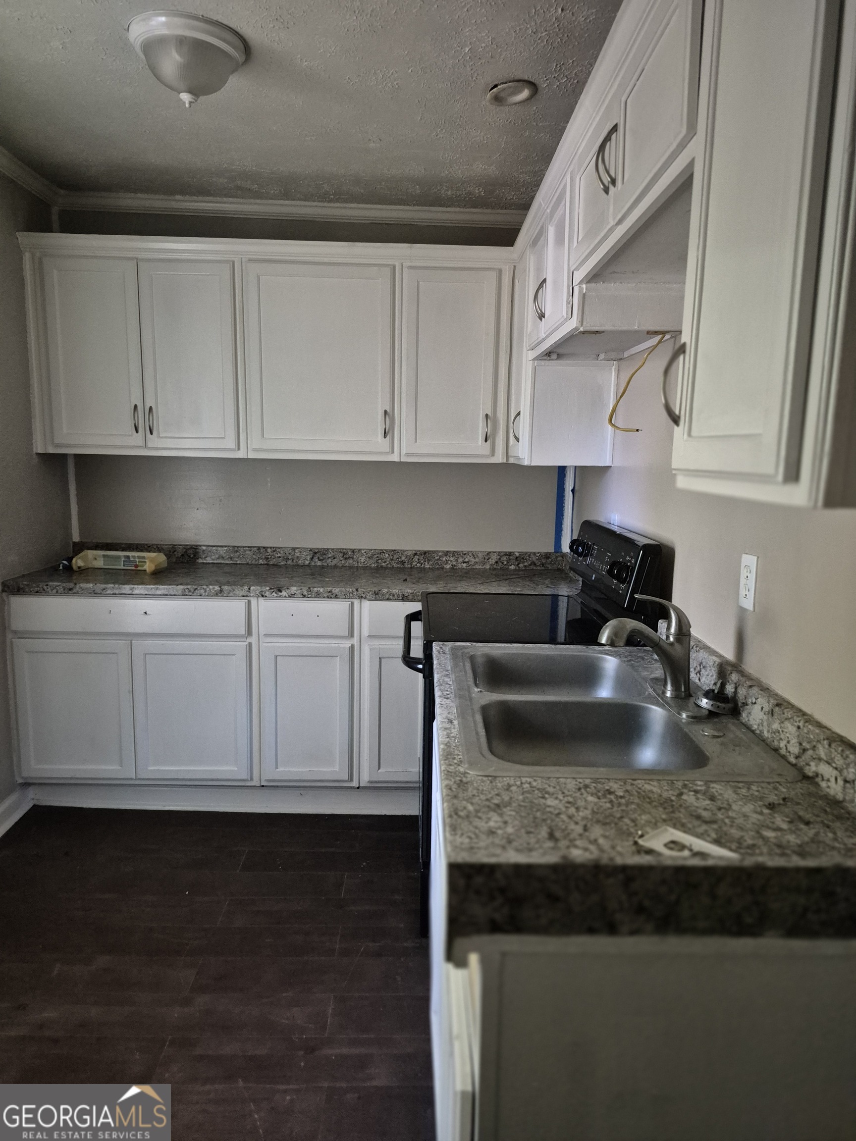 110 31st Avenue Columbus, GA 31903 - Photo 4 of 6 a kitchen with granite countertop white cabinets and a granite counter tops