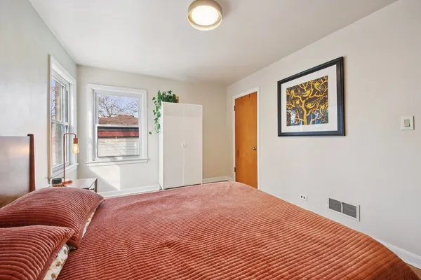 a bedroom with a large bed and a window