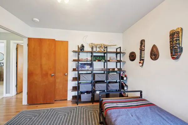 a bedroom with a bed and cabinets