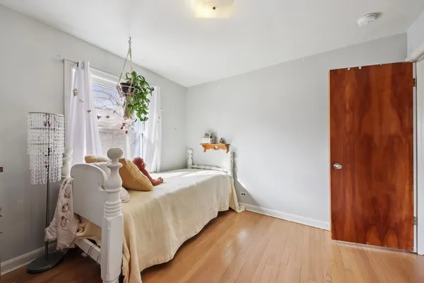 a bed room with a bed and a chandelier