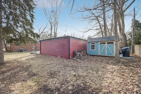 a view of a yard with a house and a tree