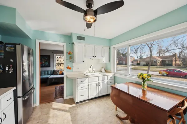 a large white kitchen with a large window
