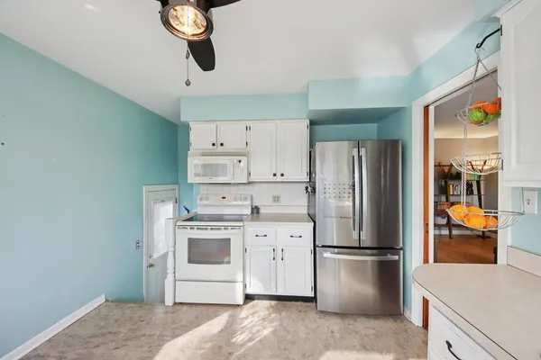 a kitchen with a refrigerator a stove top oven a sink and dishwasher