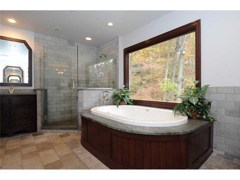71 Delafield Island Road Darien, CT 06820 - Photo 16 of 25 a bathroom with a sink a bathtub and a mirror