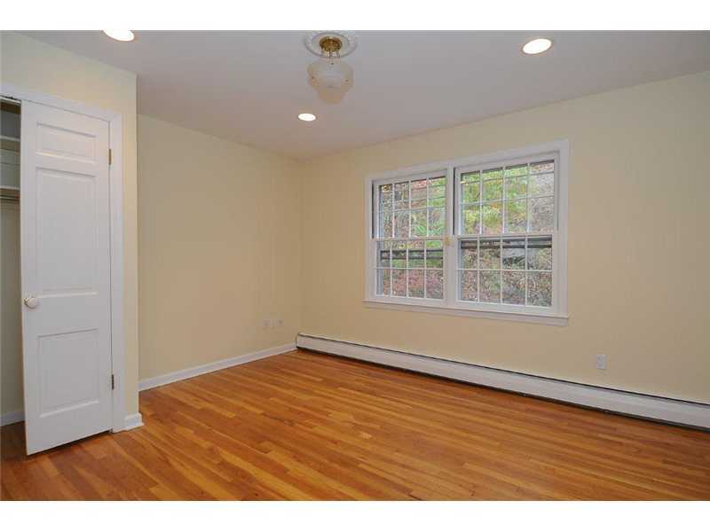 71 Delafield Island Road Darien, CT 06820 - Photo 17 of 25 an empty room with wooden floor and windows