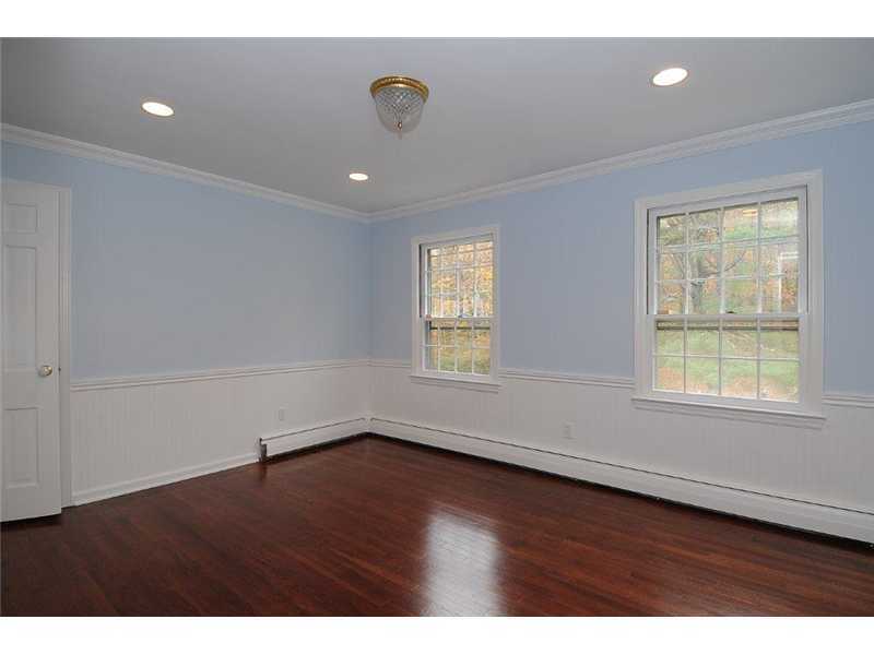 71 Delafield Island Road Darien, CT 06820 - Photo 18 of 25 an empty room with wooden floor and windows