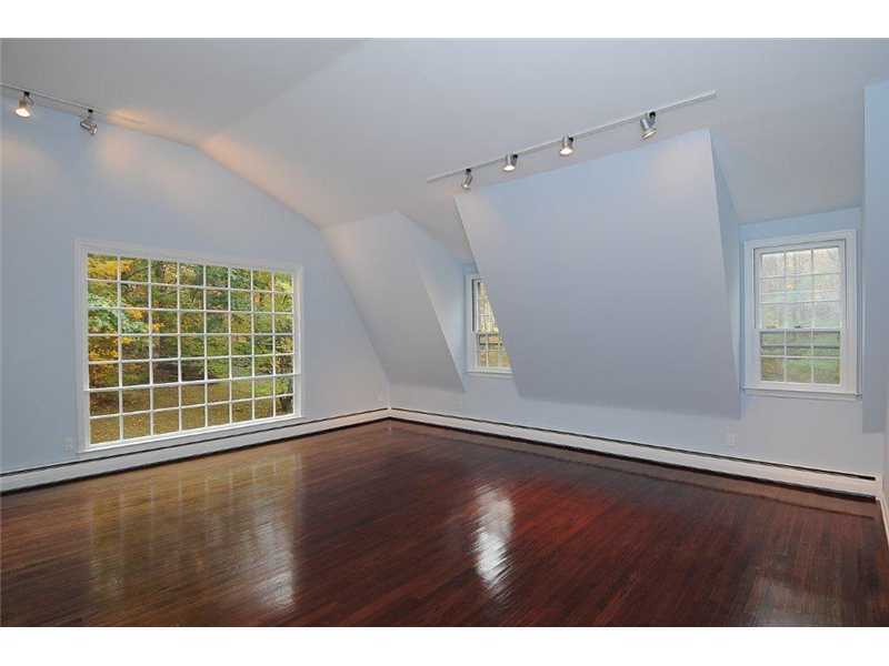 71 Delafield Island Road Darien, CT 06820 - Photo 20 of 25 a view of an empty room with a window and wooden floor