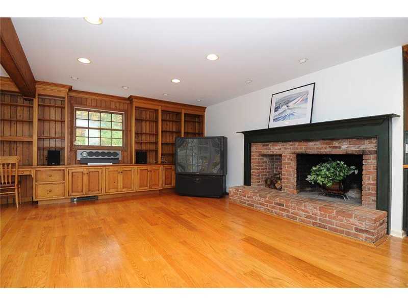 71 Delafield Island Road Darien, CT 06820 - Photo 4 of 25 a view of an empty room with a fireplace and a window
