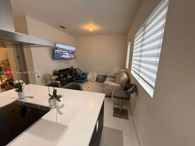 a living room with furniture a couch and dresser