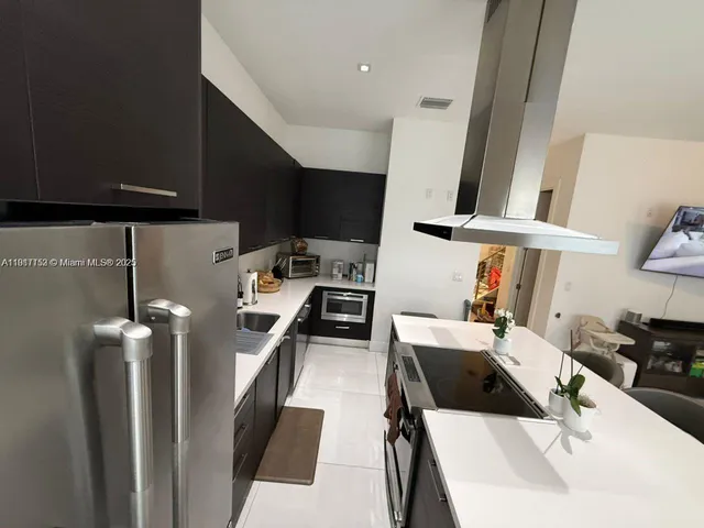 a kitchen with a sink and a stove top oven