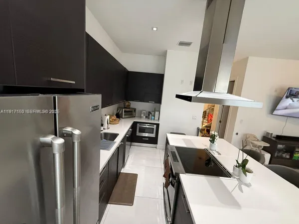 a kitchen with a sink and a stove top oven