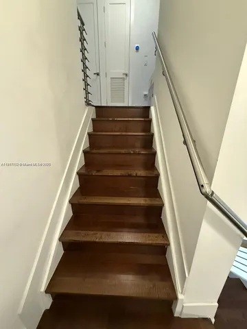 a kitchen with a sink a stove and chairs