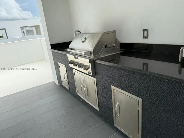a living room with furniture and floor to ceiling window