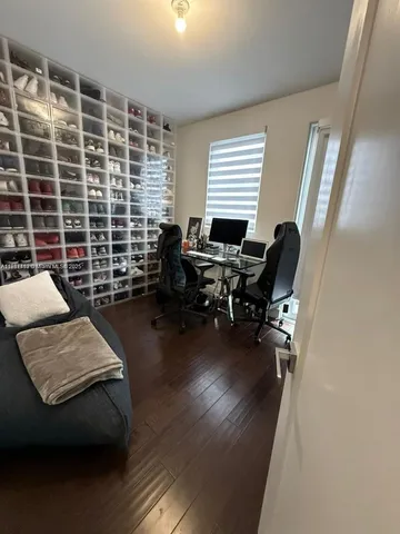 a view of a livingroom with workspace and a window