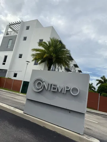 an aerial view of residential houses with outdoor space and lake view