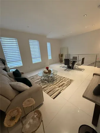 a living room with furniture a piano and a flat screen tv