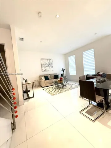 a kitchen with a sink a stove and chairs