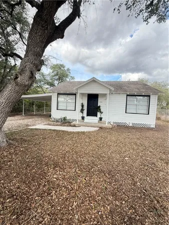 a view of house with yard and sitting area