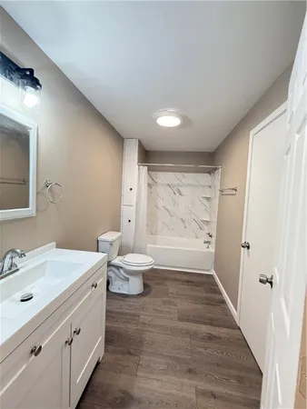 a bathroom with a double vanity sink toilet and shower