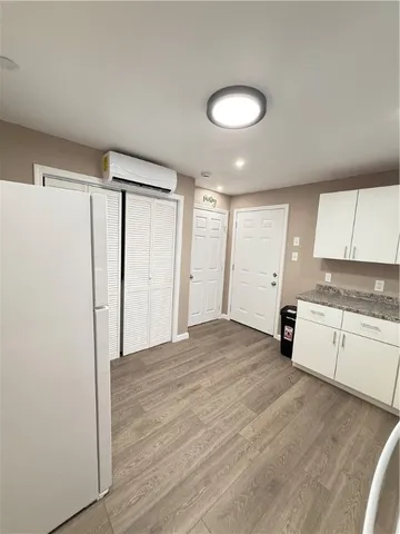a view of a kitchen with a sink and a refrigerator