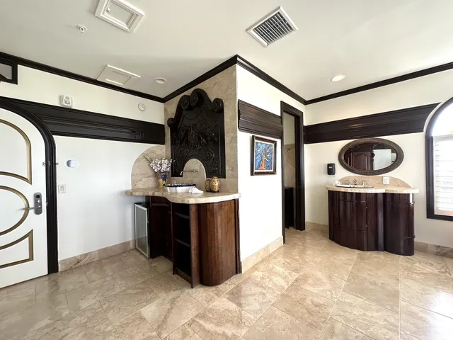 a bedroom with a bed and a flat tv screen on dresser