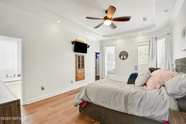 a bedroom with a large bed and a ceiling fan