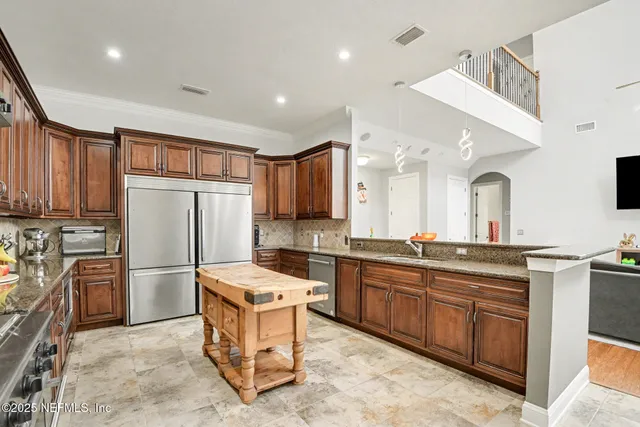 a kitchen with refrigerator cabinets and a sink