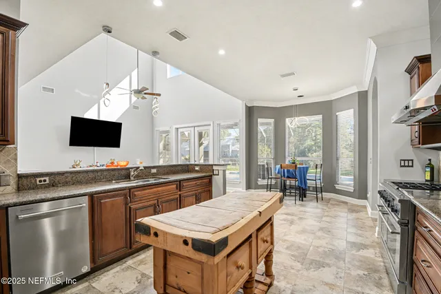 a large kitchen with kitchen island a sink counter space and stainless steel appliances