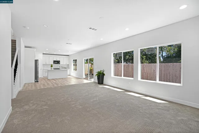 a view of a kitchen with wooden floor and windows