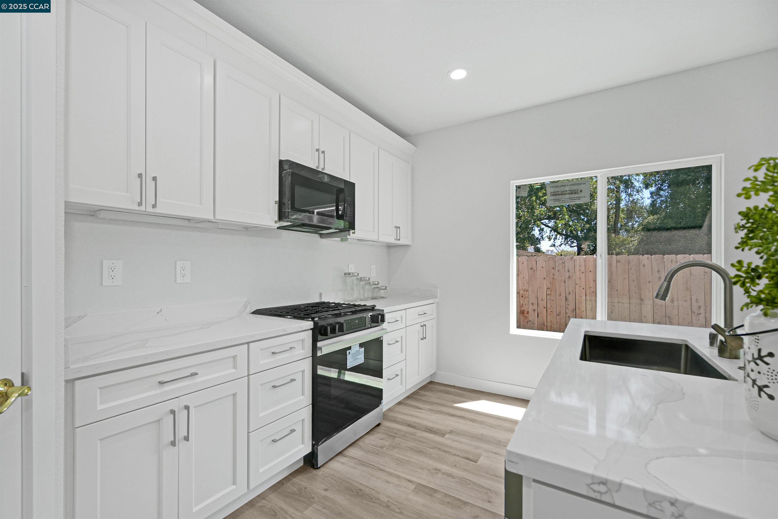 2722 Cowell Road Concord, CA 94518 - Photo 15 of 55 a kitchen with stainless steel appliances granite countertop a stove a sink and a microwave