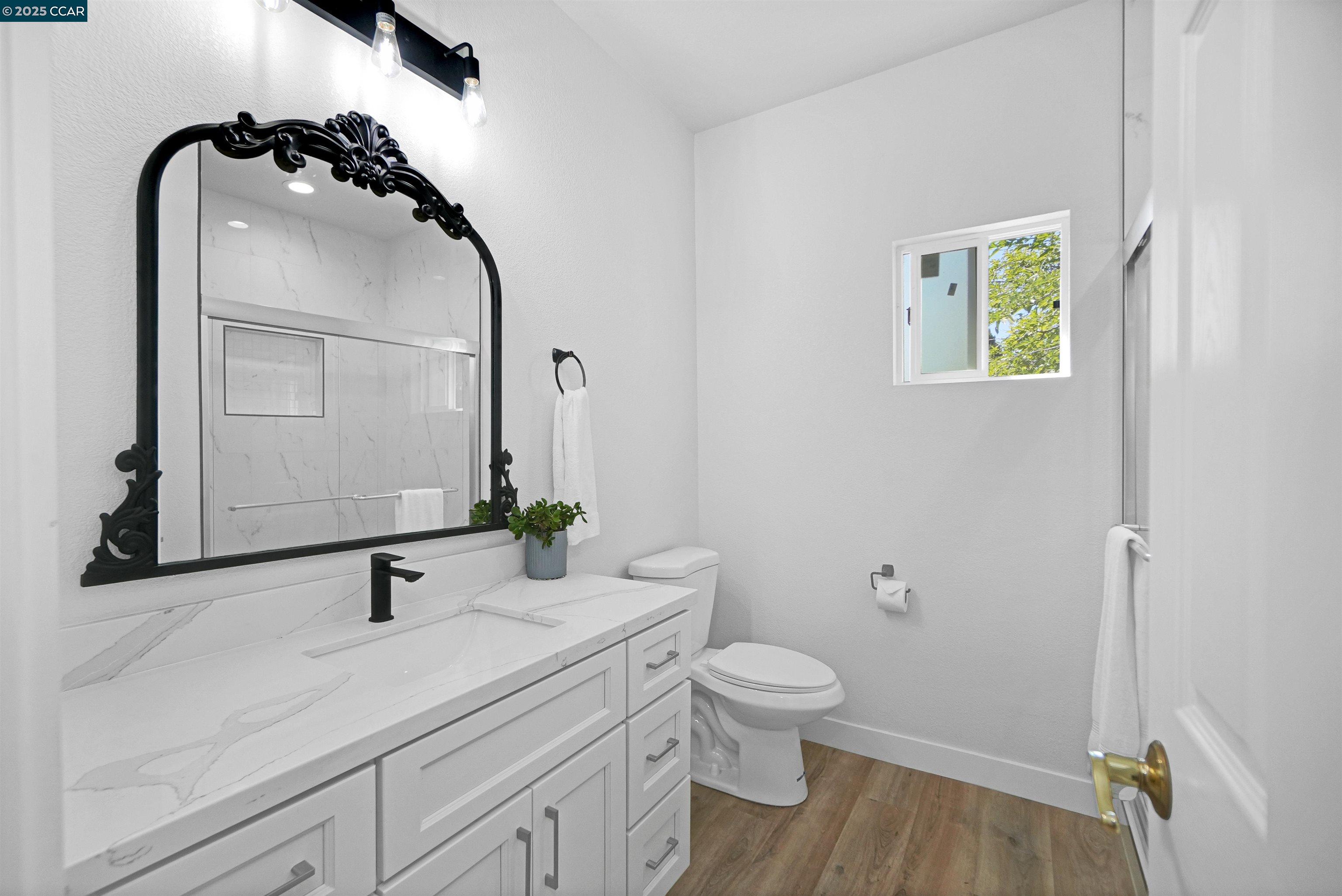 2722 Cowell Road Concord, CA 94518 - Photo 31 of 55 a bathroom with a granite countertop sink toilet and shower