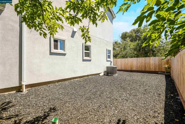 an aerial view of residential houses with outdoor space and river