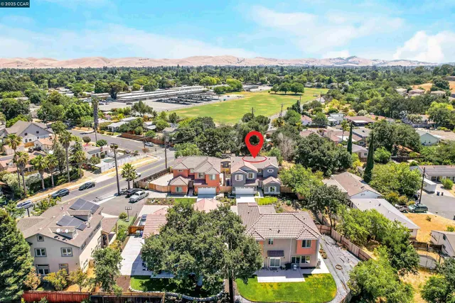 an aerial view of residential houses with green space