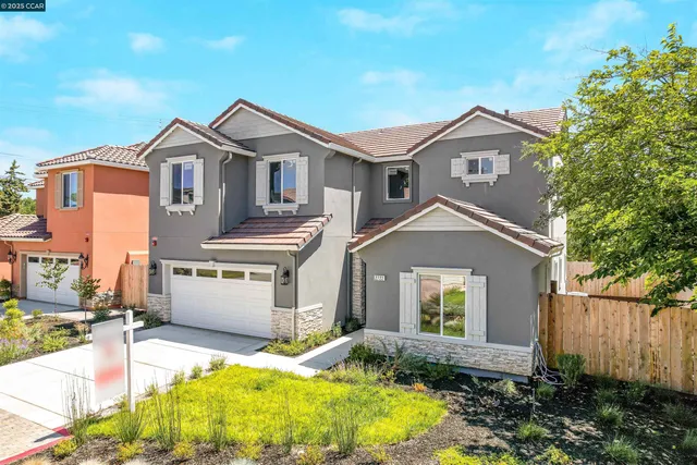 a front view of a house with a potted plant