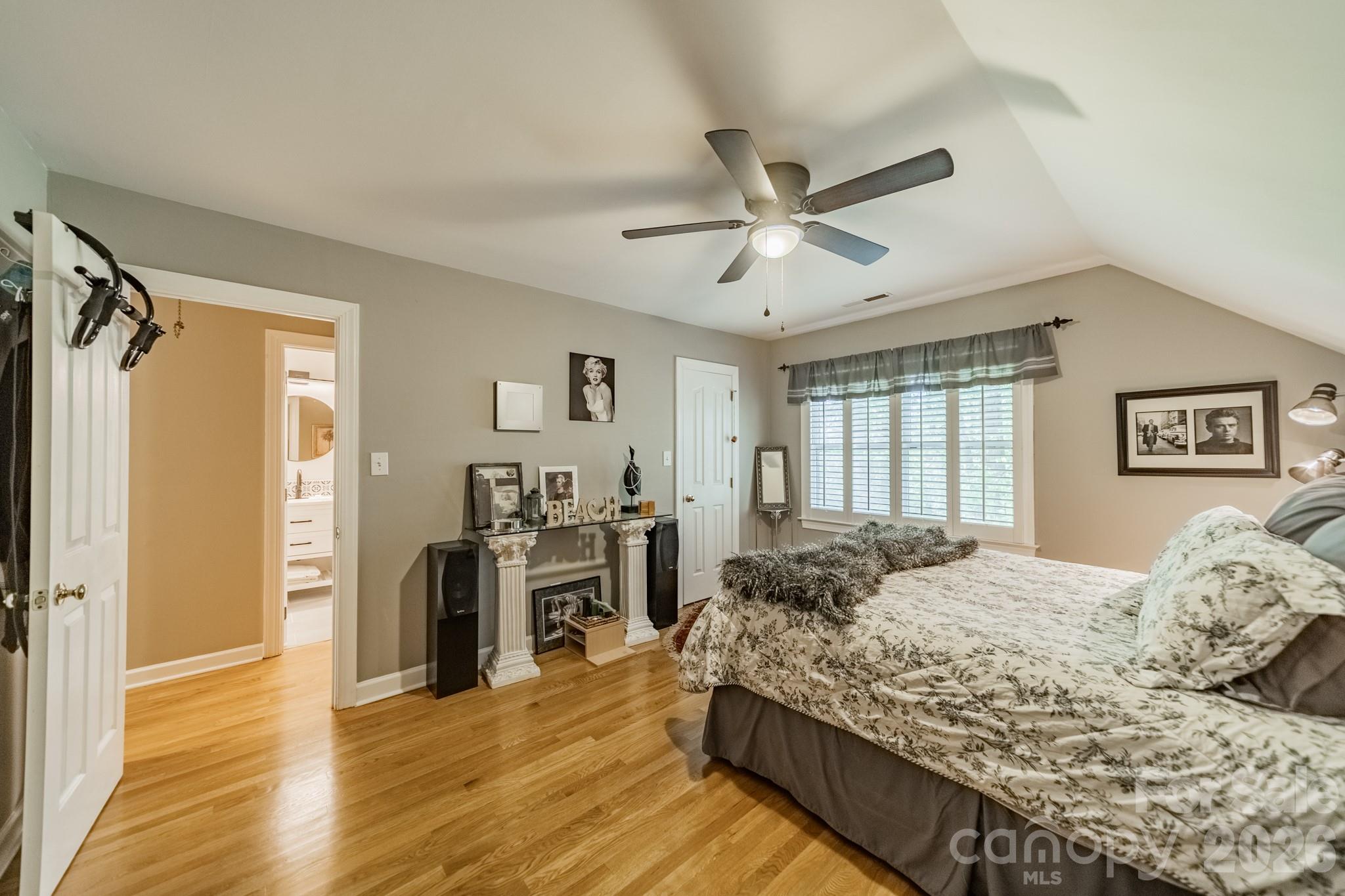11043 Seven Coves Drive Tega Cay, SC 29708 - Photo 30 of 45 a bedroom with a large bed and wooden floor