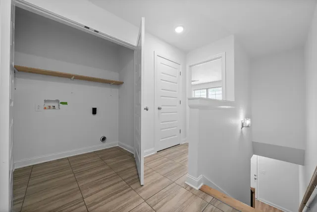 an empty room with closet and a ceiling fan