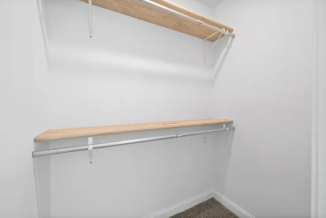 a view of an empty room with a ceiling fan