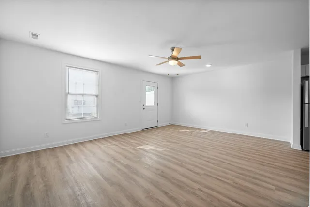 a kitchen with white cabinets stainless steel appliances and sink