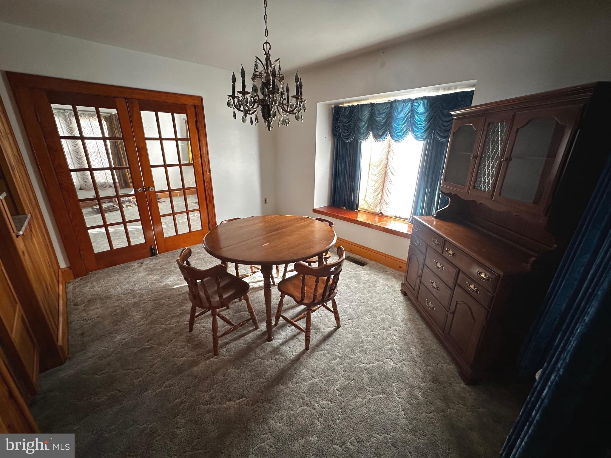 3500 Paw Paw Road Paw Paw, WV 25434 - Photo 27 of 48 a dining room with furniture a chandelier and window
