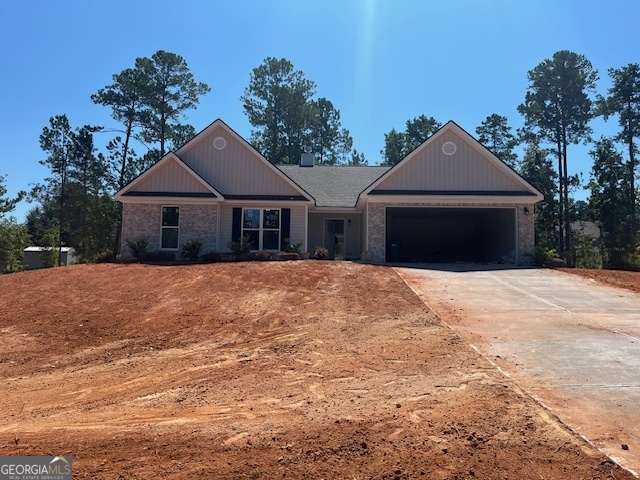 433 Riley Circle Northwest Milledgeville, GA 31061 - Photo 2 of 17 a front view of a house with a garden