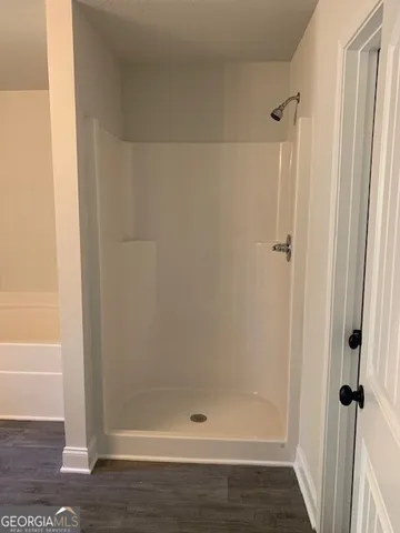 a bathroom with a glass shower door