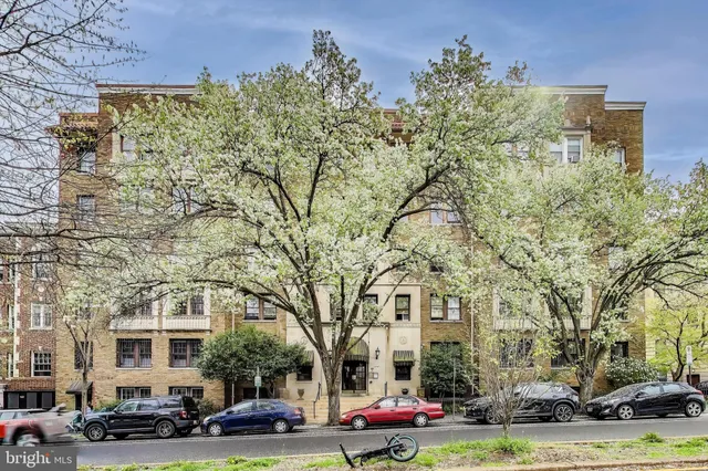 a front view of a building with trees