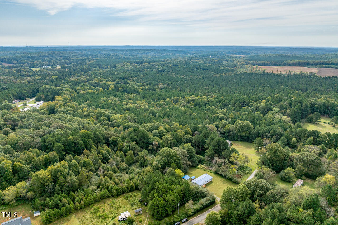 401 Major Lee Road Pittsboro, NC 27312 - Photo 4 of 23 an aerial view of residential houses with outdoor space and trees